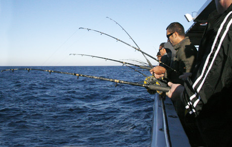 many people fishing from a charter boat