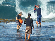 Three mollusc research staff placing abalone onto a reef